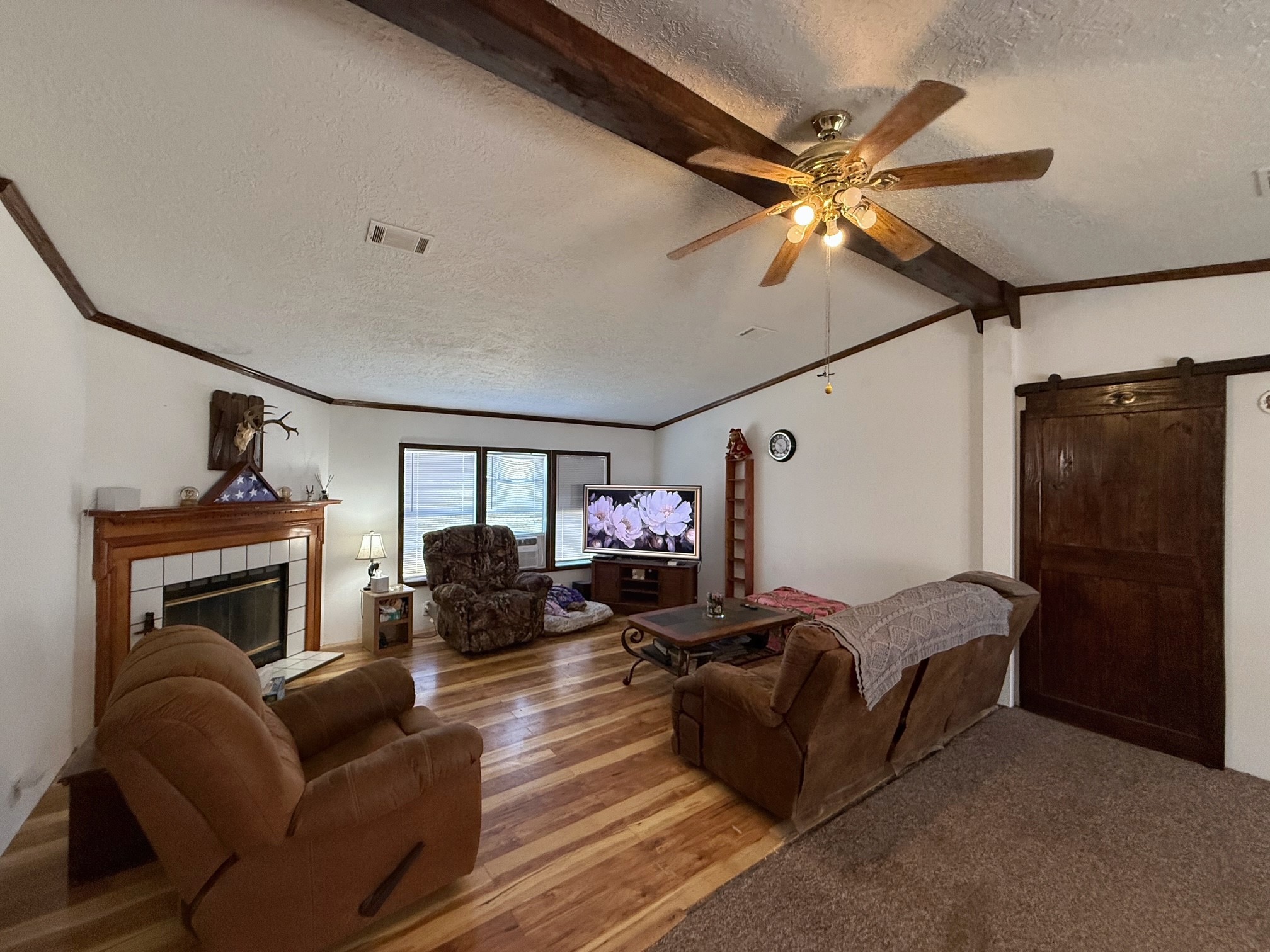 20197 Interstate 45 Buffalo, TX 75831 - Photo 6 of 30 a living room with furniture a ceiling fan and a fireplace