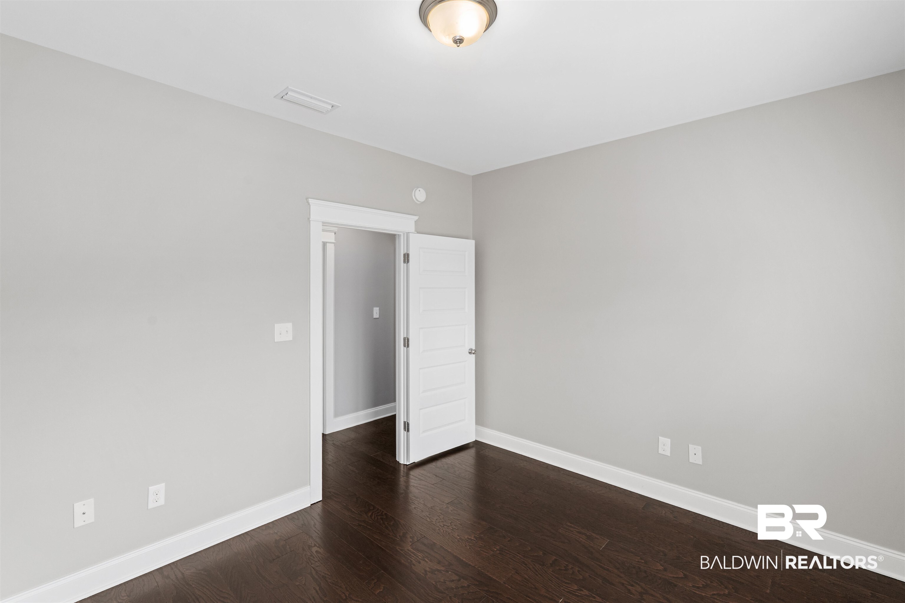 24838 Slater Mill Road Daphne, AL 36526 - Photo 22 of 46 Unfurnished room featuring dark wood finished floors and baseboards