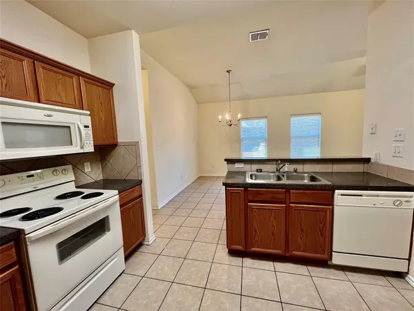 a kitchen with a stove and a microwave