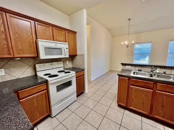 a kitchen with stainless steel appliances a stove a sink and a microwave