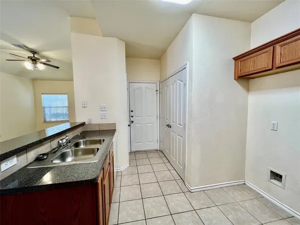 a kitchen with a stove a refrigerator and cabinets