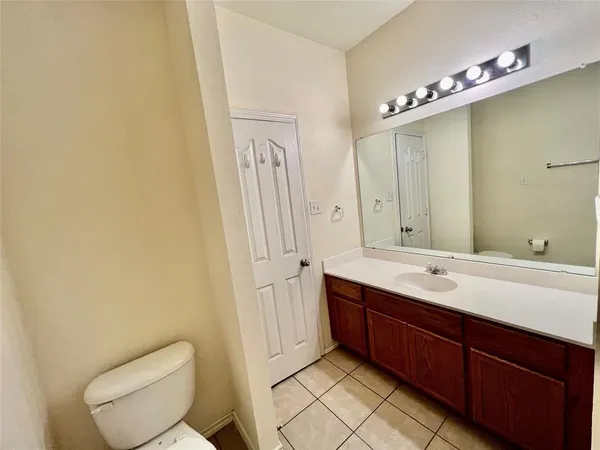 a spacious bathroom with a toilet sink and mirror