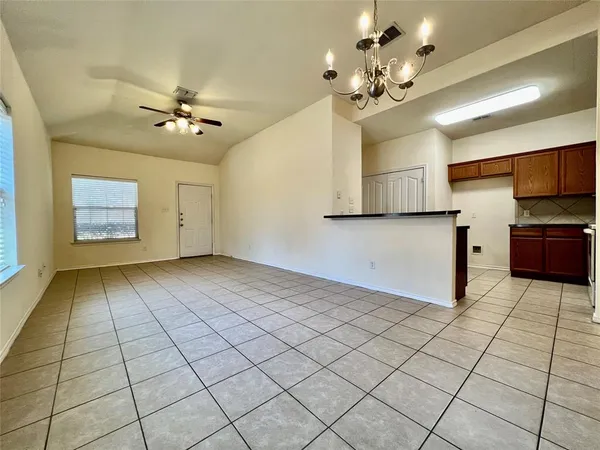 a view of a livingroom with a chandelier fan and furniture