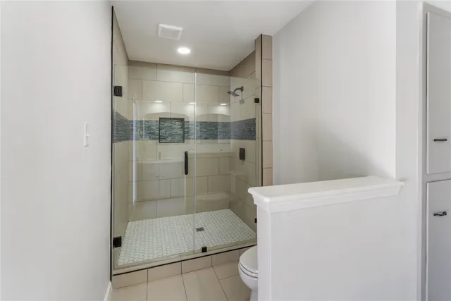 a bathroom with a shower a toilet and sink