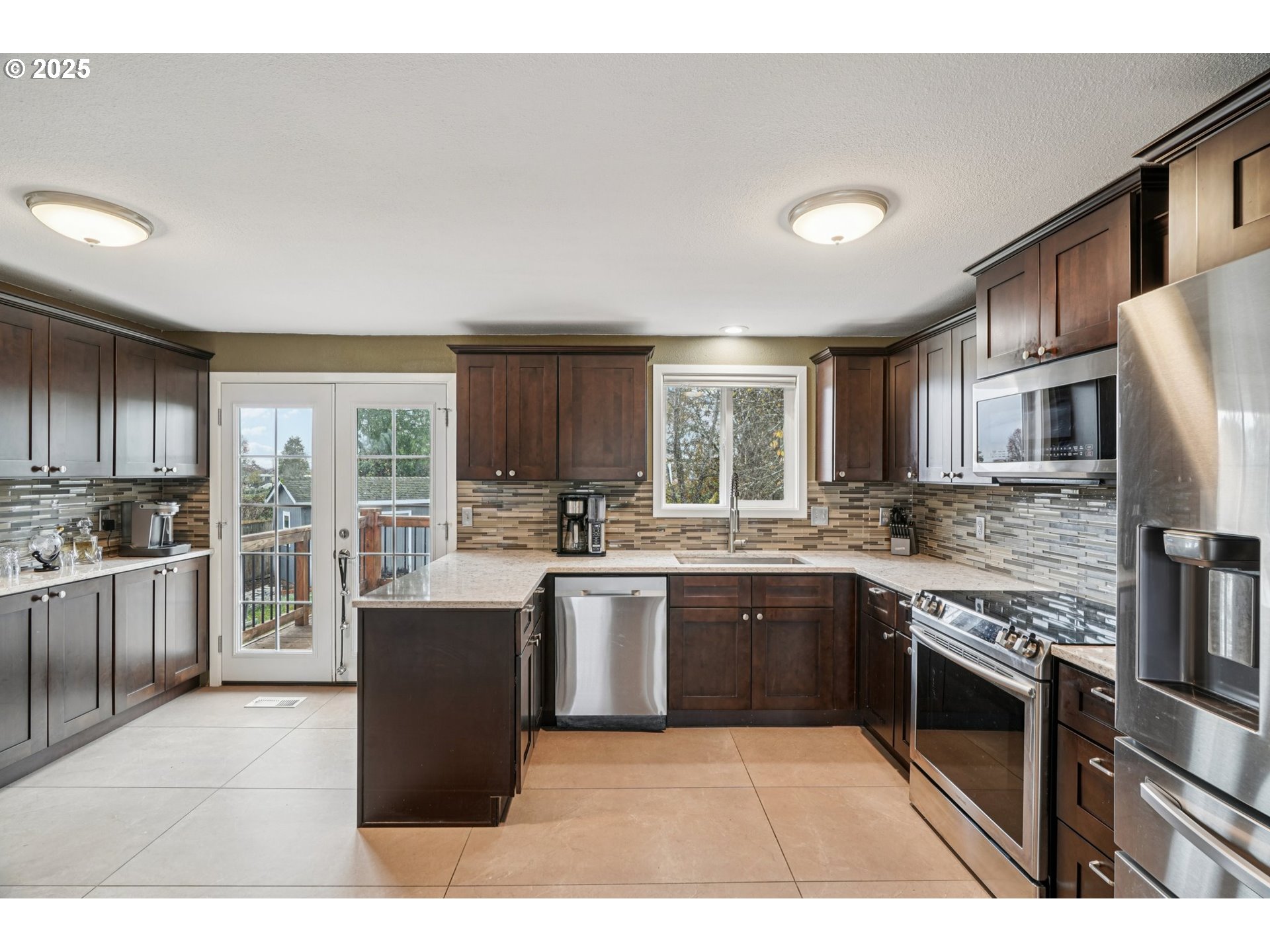 1832 Vine Court Forest Grove, OR 97116 - Photo 14 of 37 a kitchen with stainless steel appliances granite countertop a stove top oven sink and refrigerator