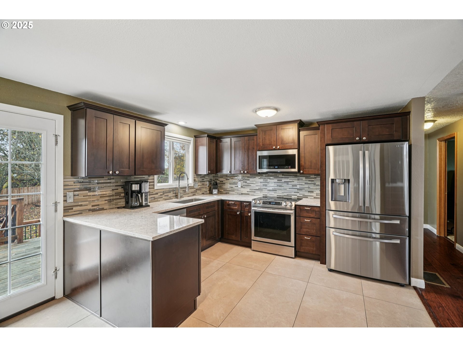 1832 Vine Court Forest Grove, OR 97116 - Photo 16 of 37 a kitchen with stainless steel appliances granite countertop a refrigerator a stove a sink and a microwave