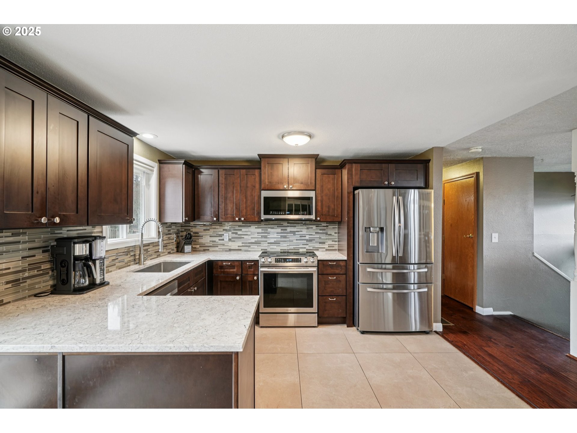 1832 Vine Court Forest Grove, OR 97116 - Photo 17 of 37 a kitchen with stainless steel appliances granite countertop a refrigerator a sink a stove and cabinets