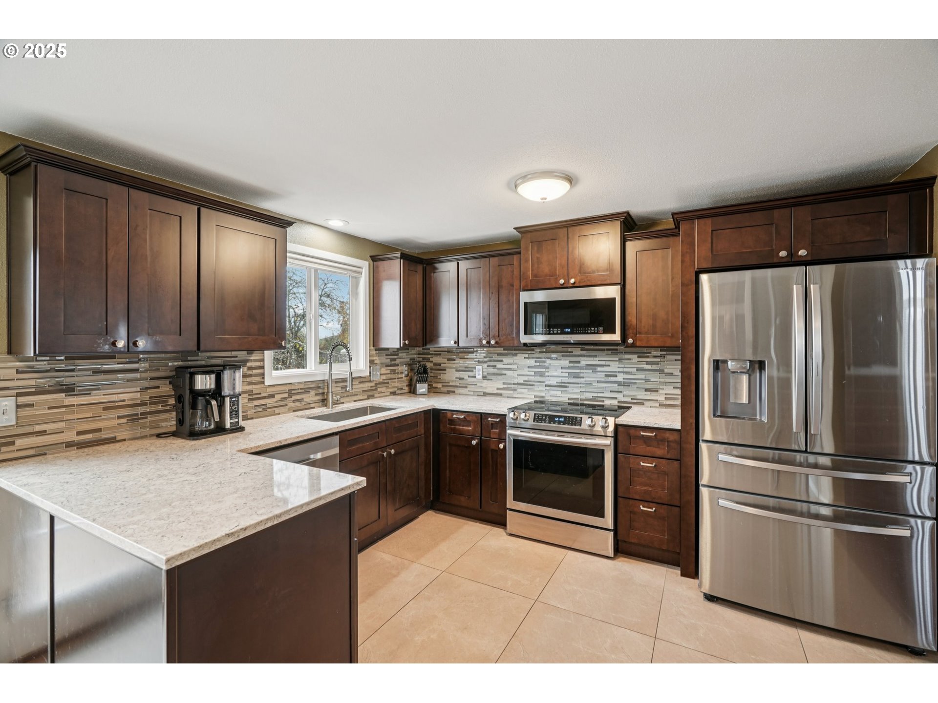 1832 Vine Court Forest Grove, OR 97116 - Photo 18 of 37 a kitchen with stainless steel appliances granite countertop a refrigerator sink and stove