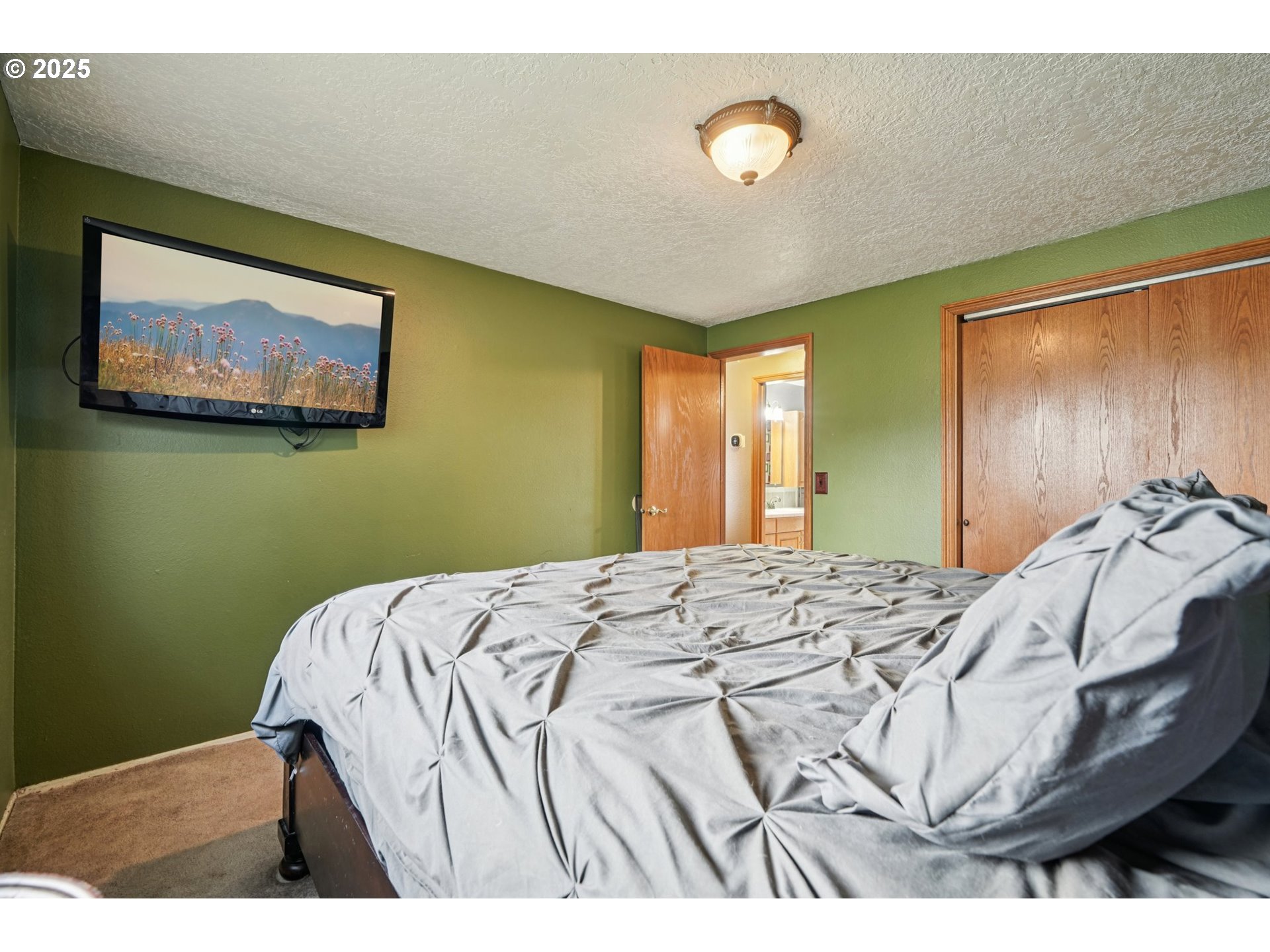 1832 Vine Court Forest Grove, OR 97116 - Photo 20 of 37 a bedroom with a bed and a painting on the wall