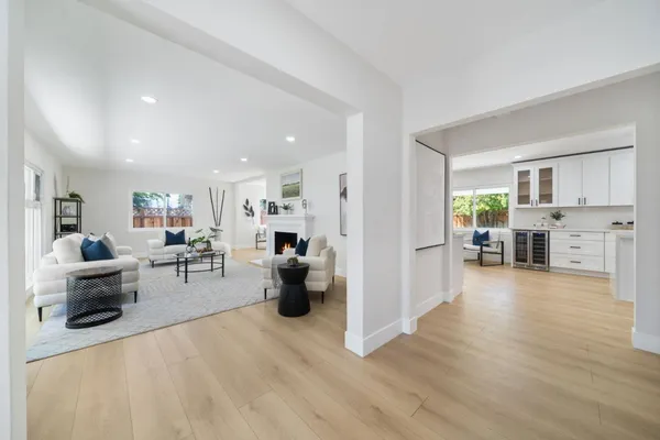 a view of a living room kitchen and a wooden floor