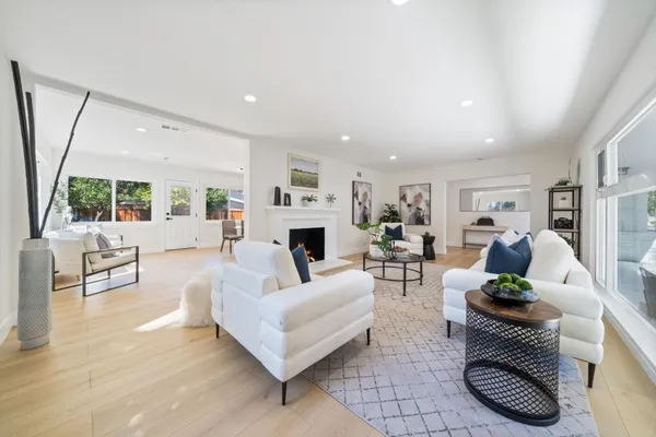 a living room with furniture a fireplace and a flat screen tv