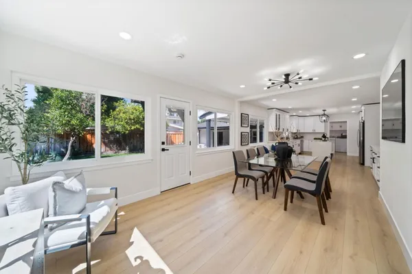 a dining room with furniture and wooden floor