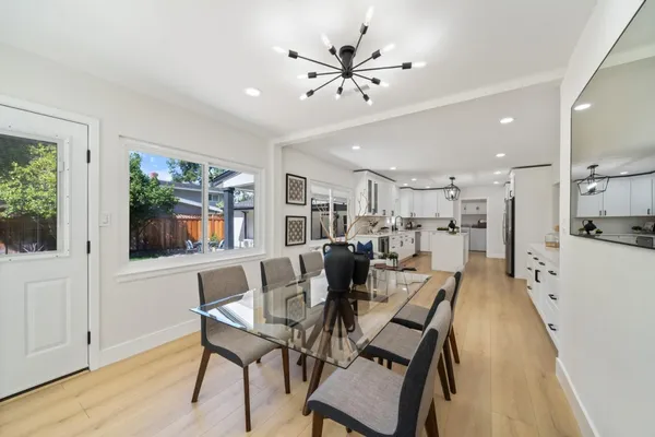 a view of a dining room with furniture and wooden floor