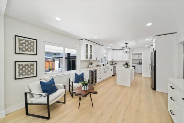 a living room with stainless steel appliances kitchen island granite countertop furniture and a kitchen view