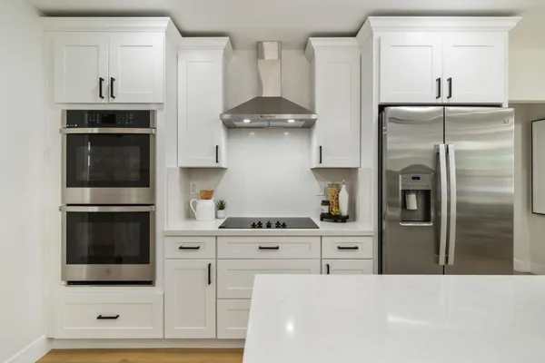 a kitchen with stainless steel appliances kitchen island a refrigerator sink and stove