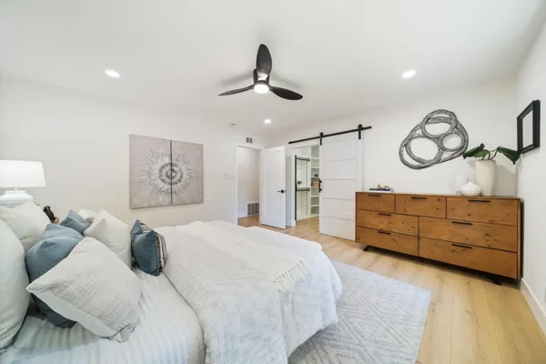 a bedroom with a bed and ceiling fan