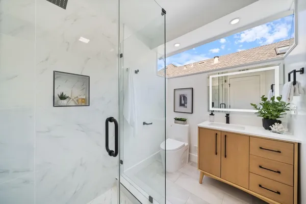 a bathroom with a tub sink and mirror