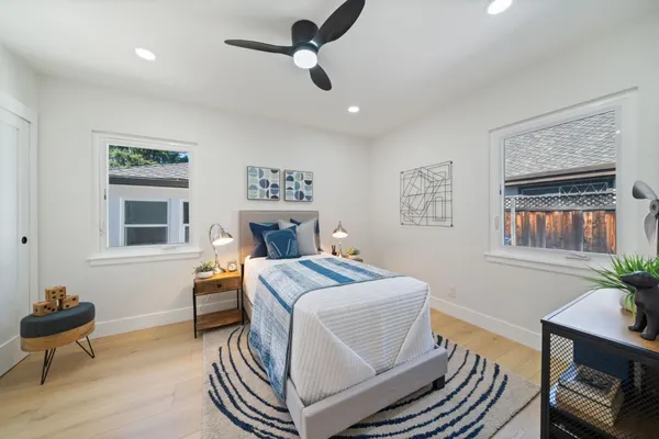 a room with a bed and a chandelier