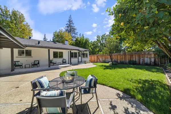 a swimming pool with outdoor seating and yard
