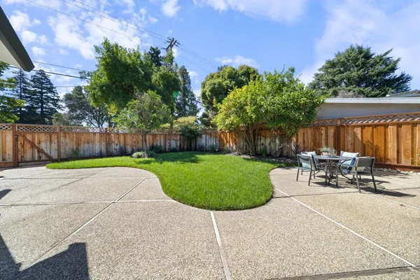 a view of a patio with a table and chairs