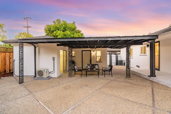 a view of a hallway with wooden floor and a potted plant