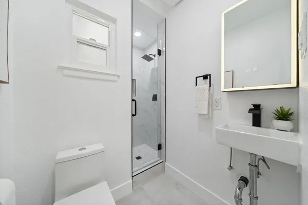 a bed room with a bed and a mirror