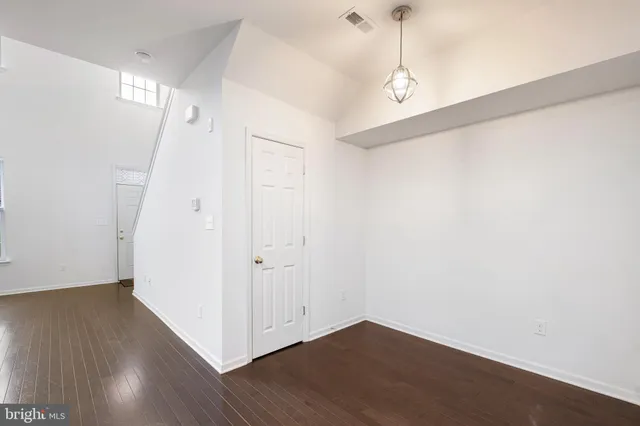 a view of a room with wooden floor