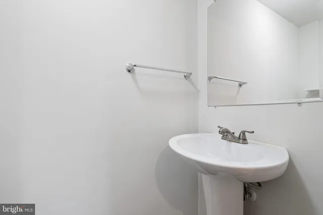 a bathroom with a sink and mirror