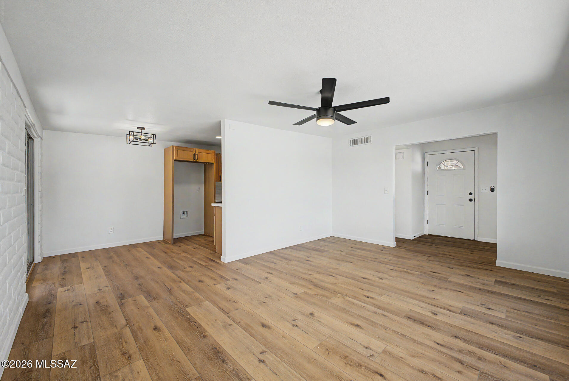 3402 South Kolb Road Tucson, AZ 85730 - Photo 7 of 32 a view of a livingroom with a hardwood floor and a ceiling fan