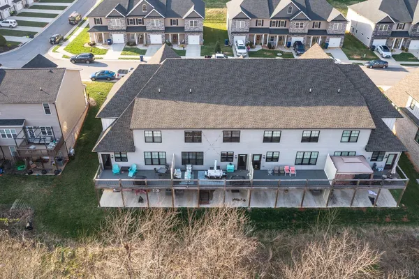 a kitchen with white cabinets and a window