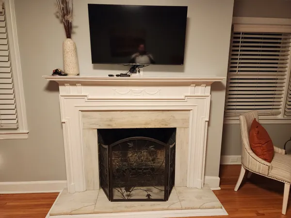 a bedroom with a bed and a fireplace