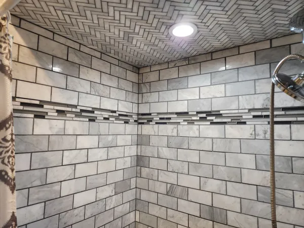 a view of hallway with couch and painting on wall