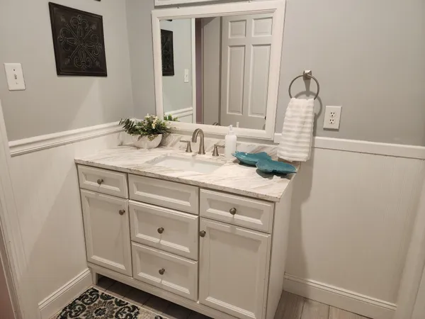 a bathroom with a sink toilet and mirror