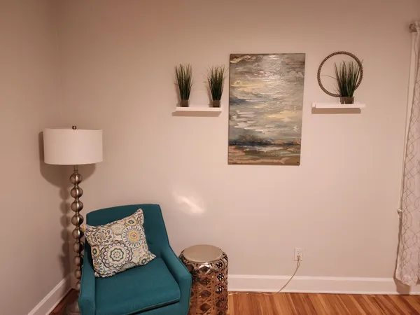 a view of a house with a yard and potted plants