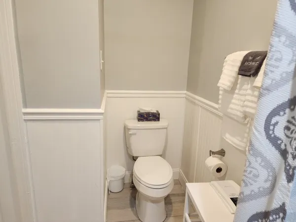 a view of residential houses with snow on the road