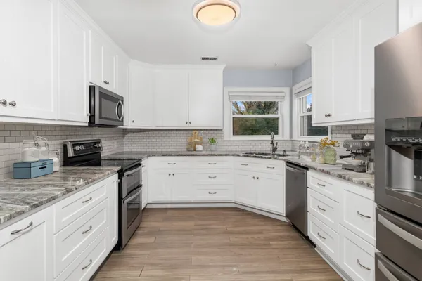 a view of a kitchen with dining table and chairs