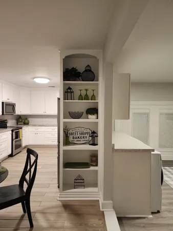 a view of a living room and kitchen with furniture