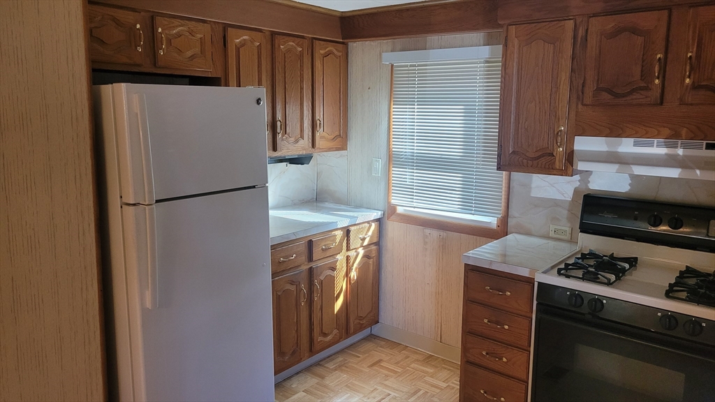 846 Broadway, Unit 40 Saugus, MA 01906 - Photo 2 of 13 a kitchen with a refrigerator stove and cabinets