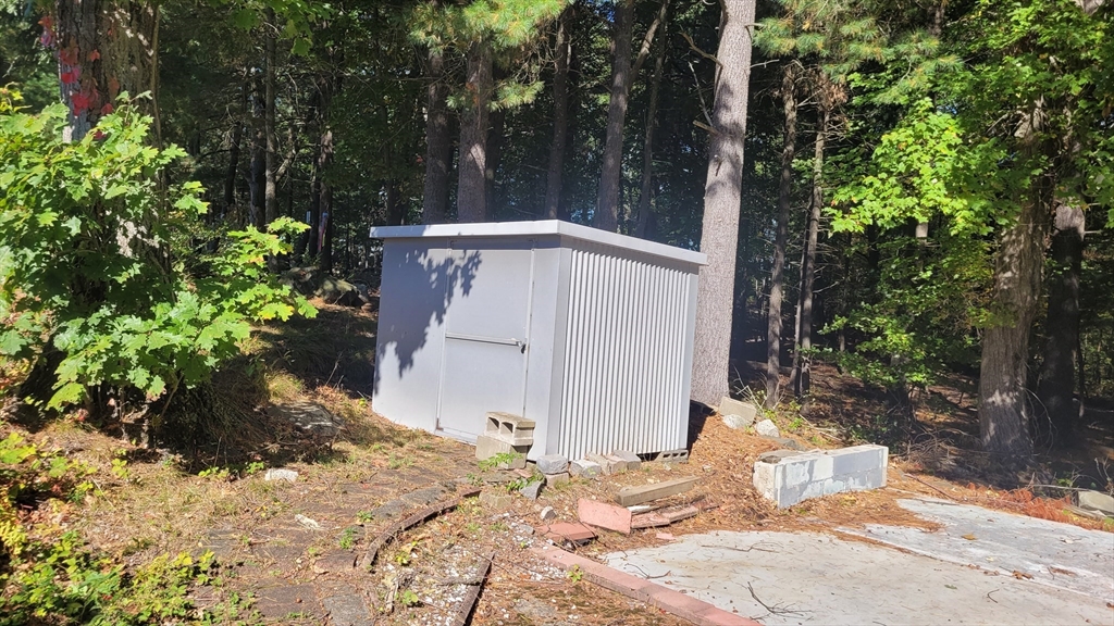 846 Broadway, Unit 40 Saugus, MA 01906 - Photo 6 of 13 a backyard of a house with large trees and wooden fence
