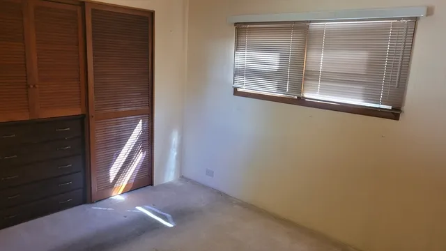 a view of a closet area with an empty room