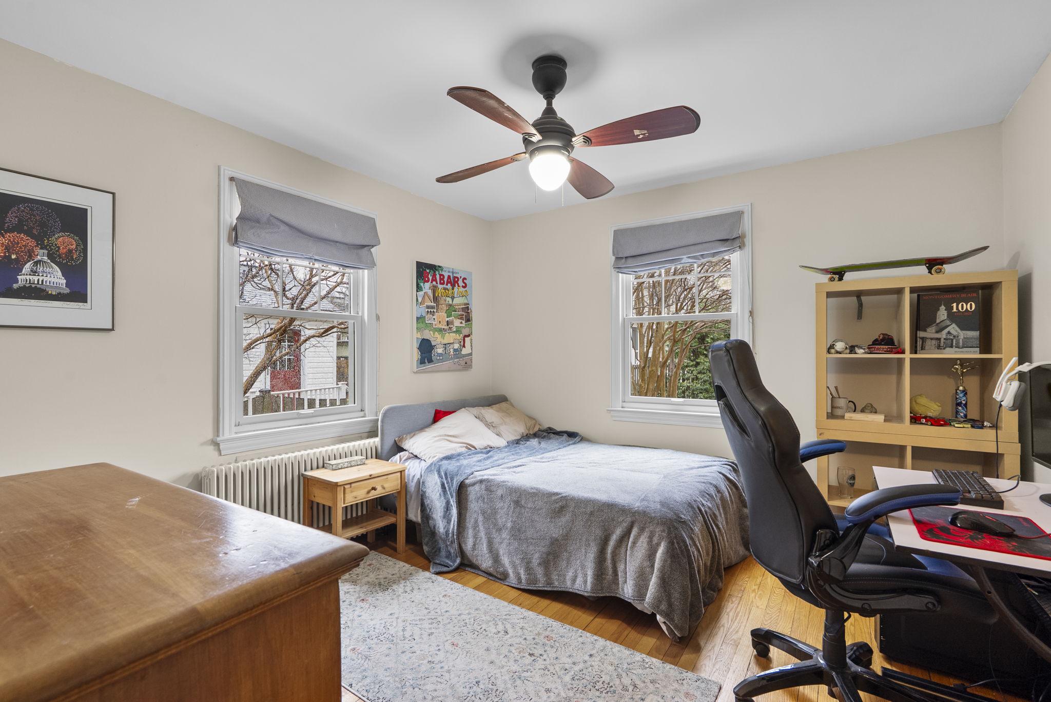713 Gist Avenue Silver Spring, MD 20910 - Photo 15 of 35 a bedroom with a bed and a chandelier