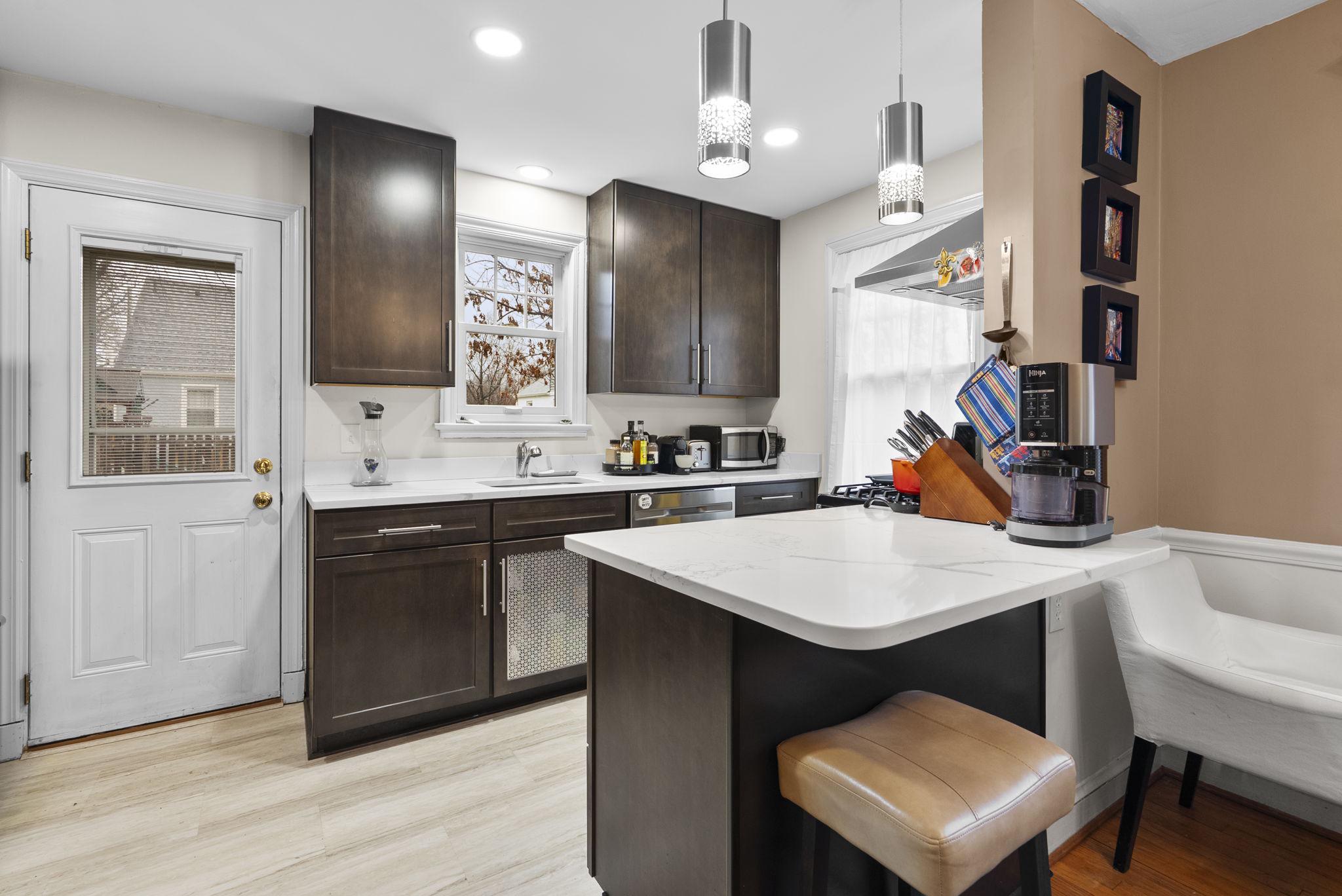713 Gist Avenue Silver Spring, MD 20910 - Photo 9 of 35 a kitchen with a sink cabinets and wooden floor
