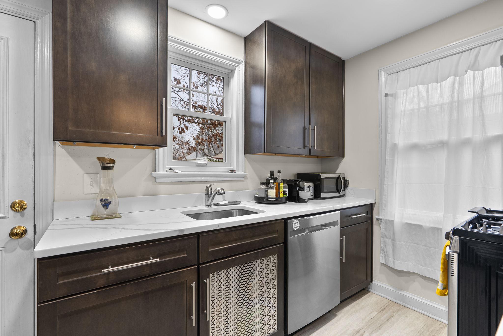 713 Gist Avenue Silver Spring, MD 20910 - Photo 10 of 35 a kitchen with a sink cabinets and window