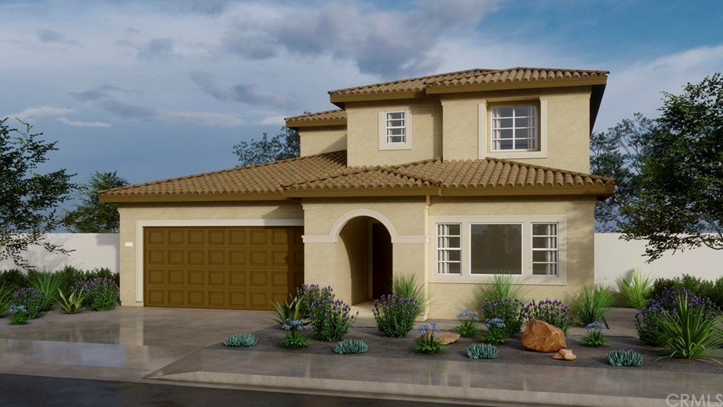 a front view of a house with plants