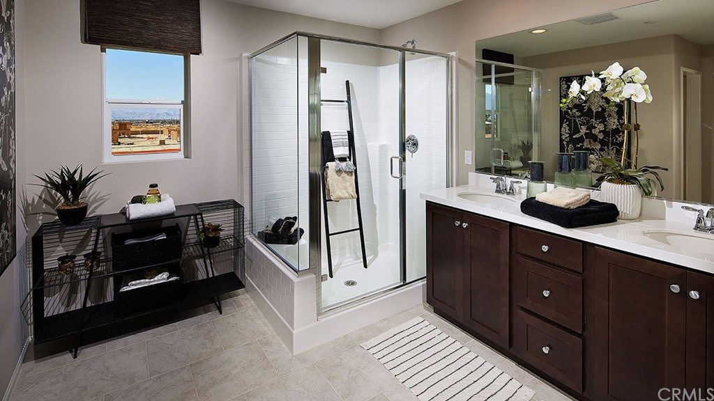 44324 Beringer Drive Indio, CA 92203 - Photo 13 of 14 a spacious bathroom with a double vanity sink a large mirror and a shower