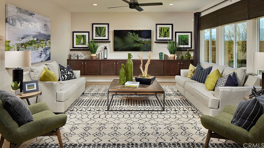 44324 Beringer Drive Indio, CA 92203 - Photo 6 of 14 a living room with furniture a flat screen tv and a floor to ceiling window