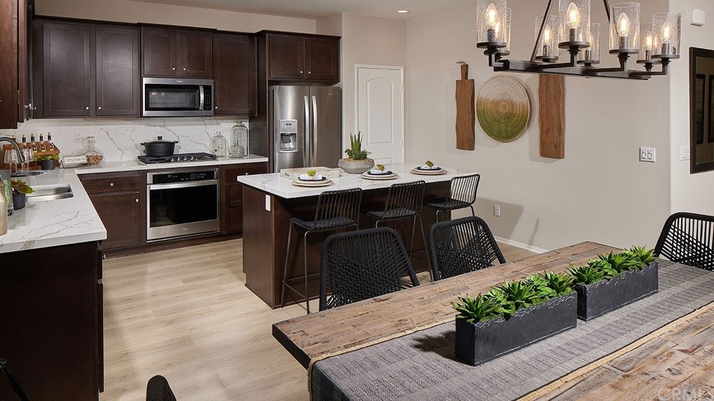 44324 Beringer Drive Indio, CA 92203 - Photo 9 of 14 a kitchen with a sink refrigerator and microwave
