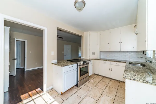 a kitchen with a stove a sink and a refrigerator