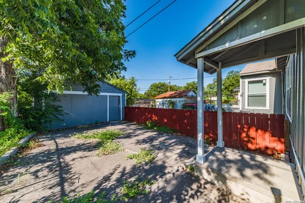 a backyard of a house with barbeque oven
