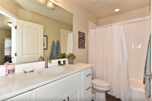 1622 Canyon Tree Drive St. George, UT 84770 - Photo 20 of 34 Bathroom featuring a white vanity with an undermount sink, brushed nickel faucet, and a large wall-mounted mirror